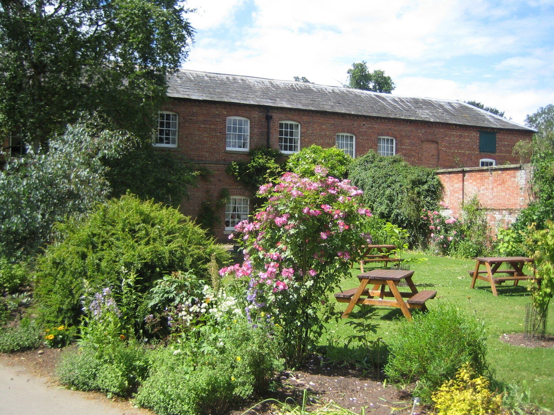 A brick building with a picnic table in front of it