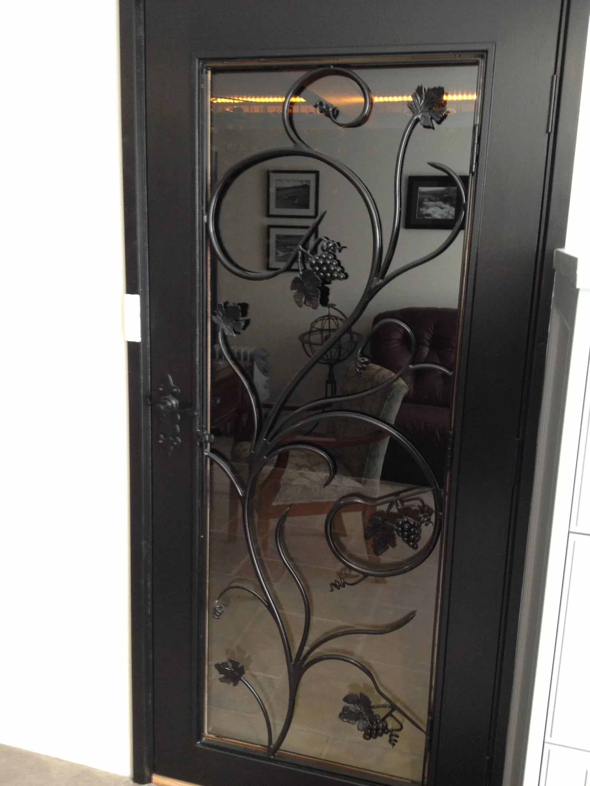 A black door with a wrought iron design on it