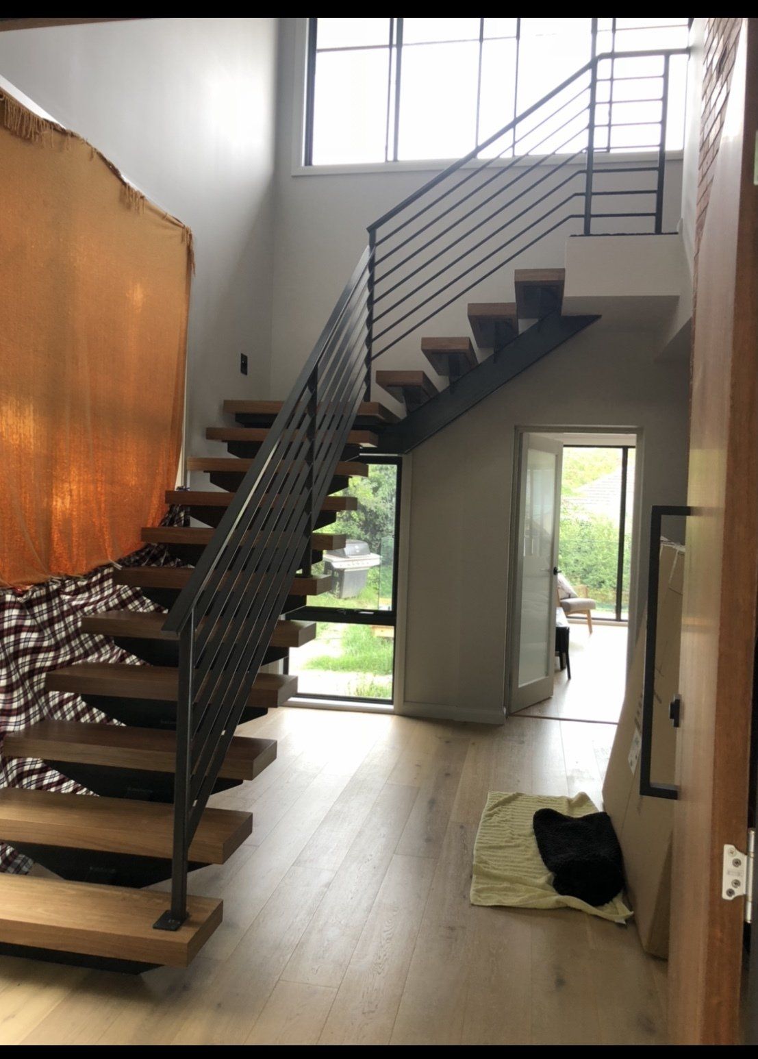 A wooden staircase with a metal railing in a house