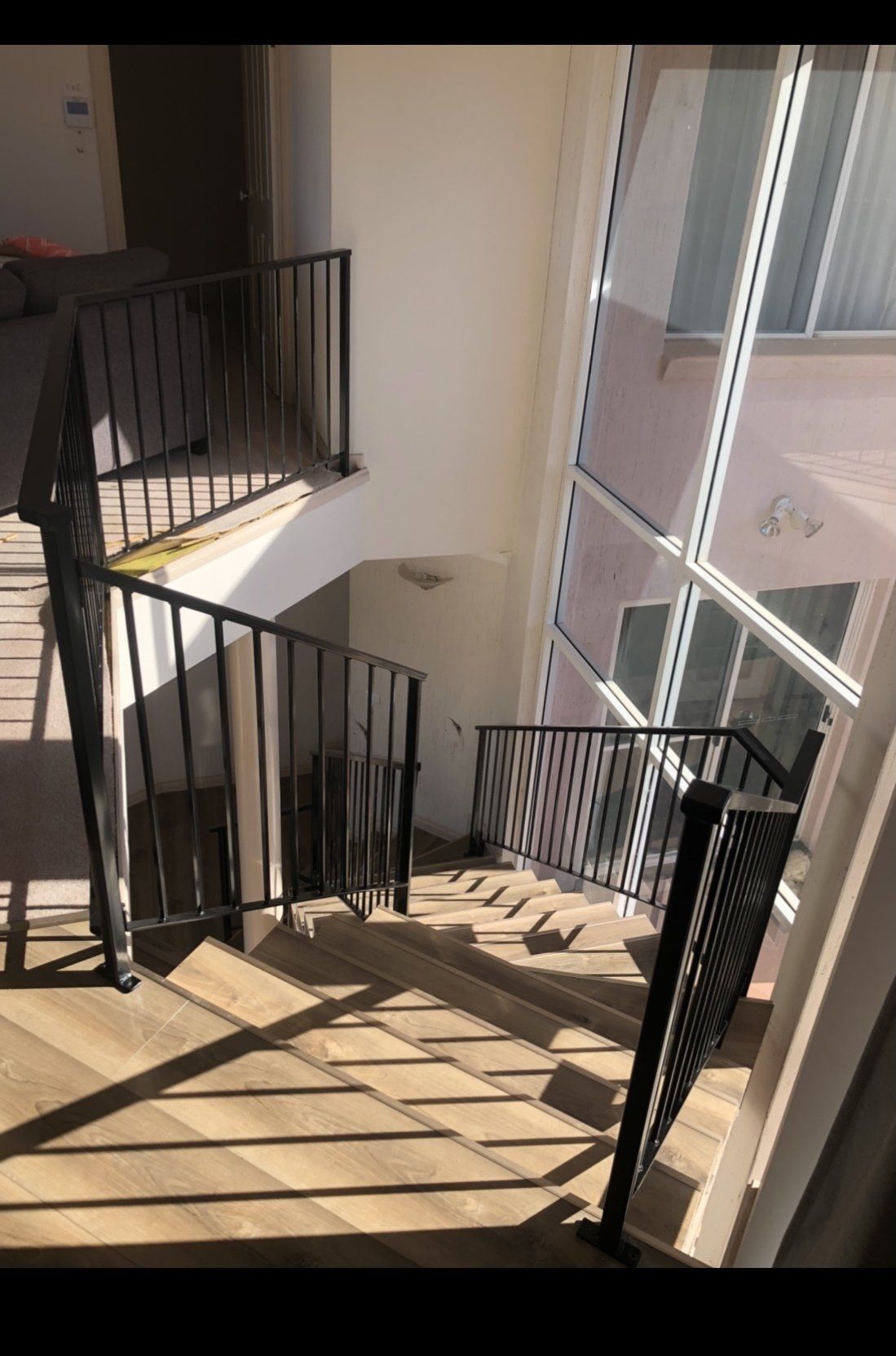 A spiral staircase in a building with a metal railing.