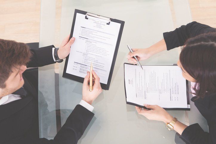 Business people discussing over documents — Employment Law in Baltimore, MD