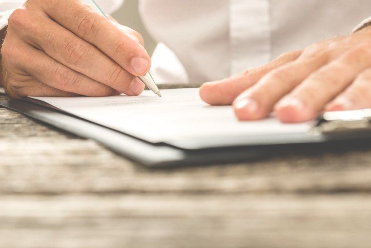 Male signing a employment contract — Employment Law in Baltimore, MD Male signing a employment contract — Employment Law in Baltimore, MD