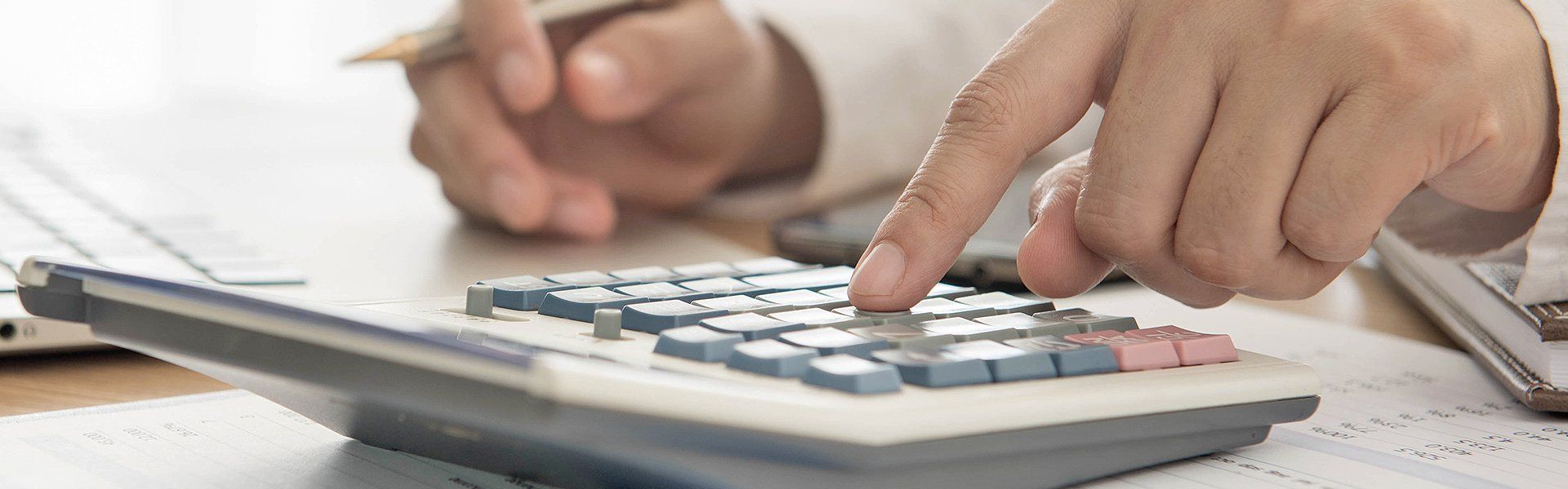 a man using calculator for payroll calculation