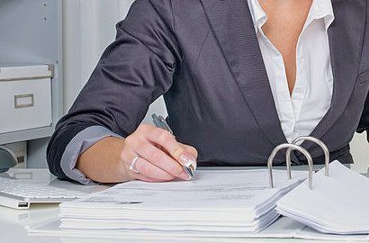 a chartered accountant writing on a document