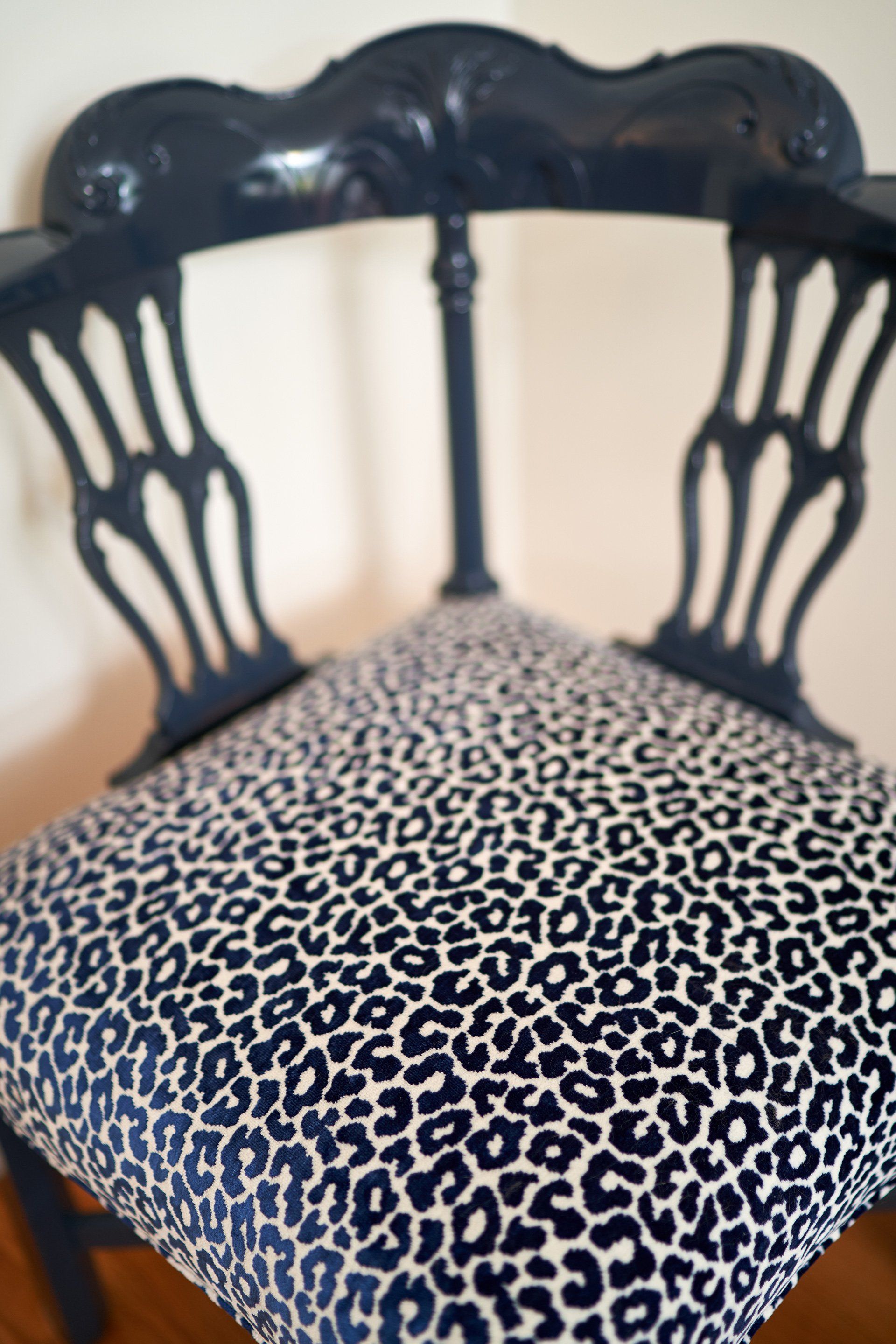 Blue chair with leopard print seat.