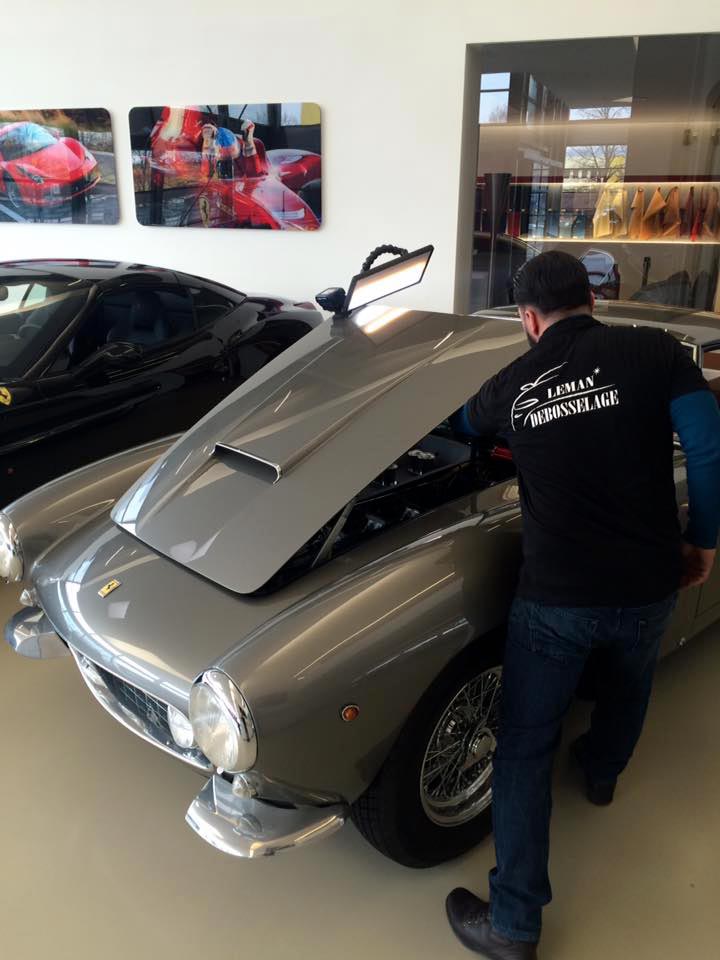 man fixing hood