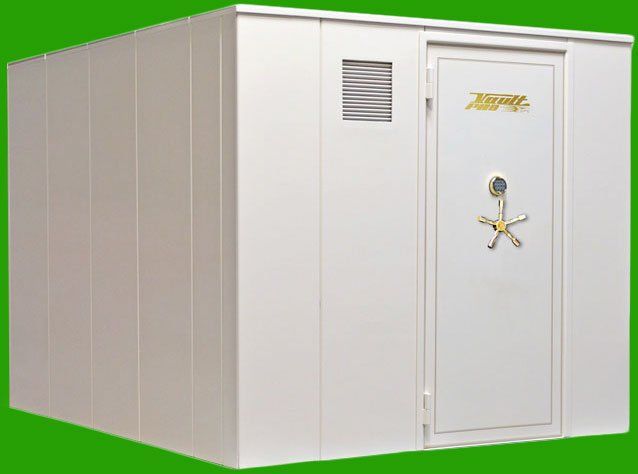 White industrial storage unit with a secure door and vent panels on a green background