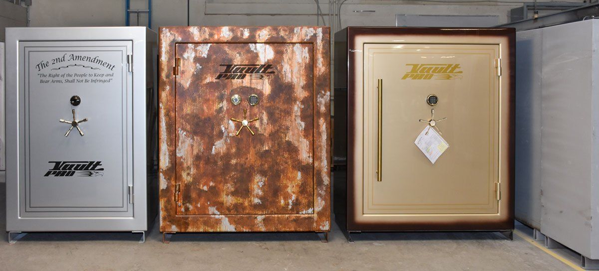 Three custom safes are sitting next to each other in a room. Made by Vault Pro USA