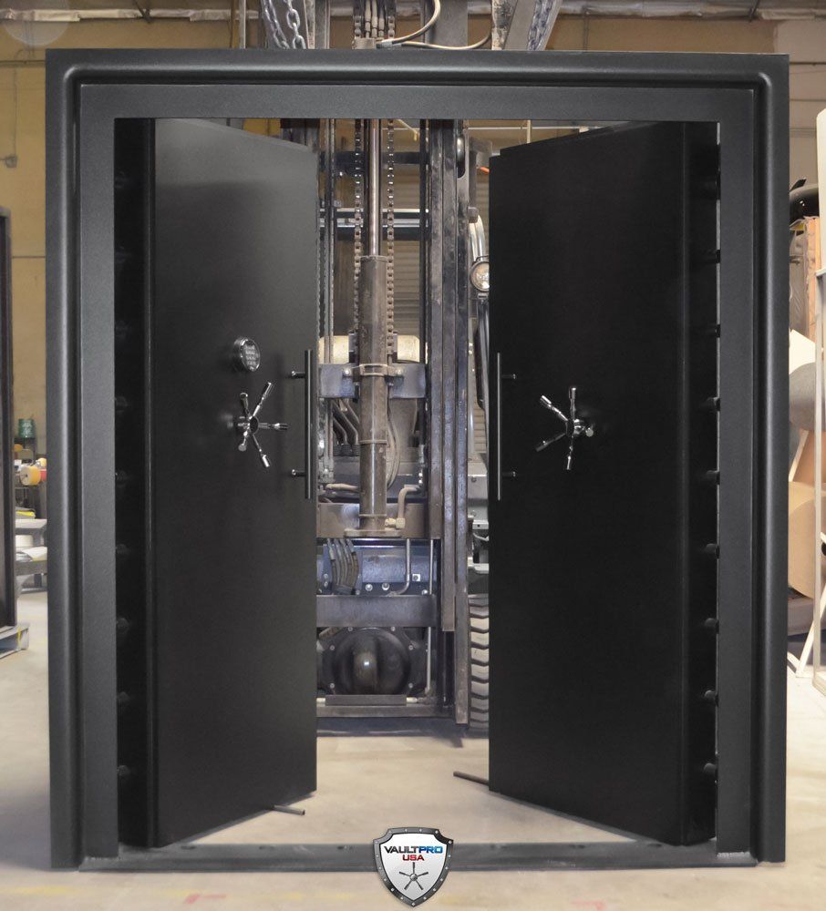 Open vault door with two black metal doors revealing a secure interior chamber.