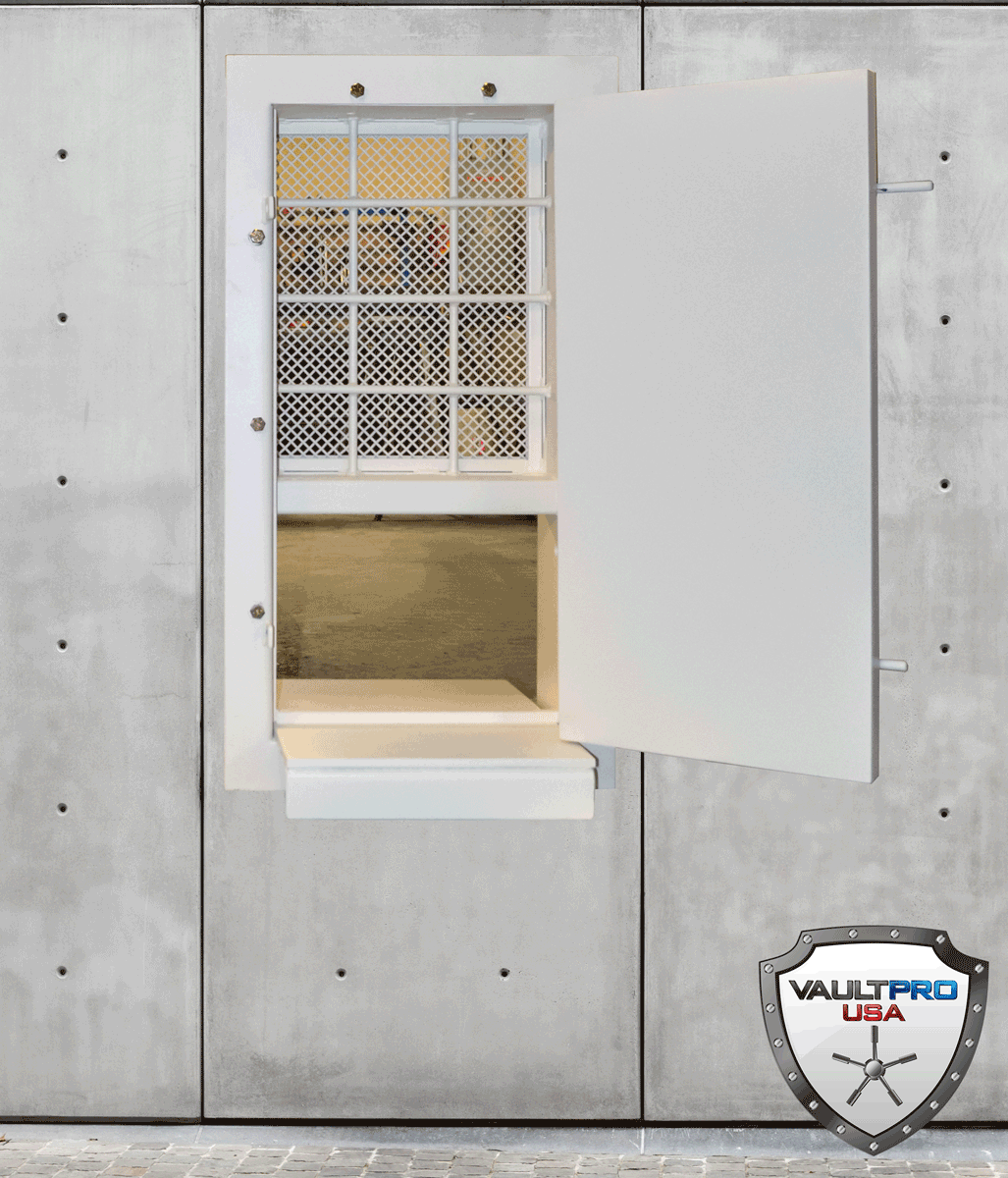 Open wall-mounted metal cabinet with a hinged door and perforated upper panel on a gray wall.