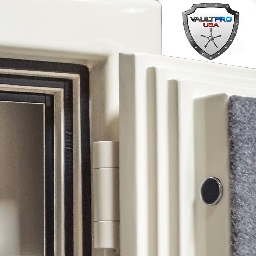 Close-up of a white safe door with hinge, black handle, and VaultPro USA shield logo.