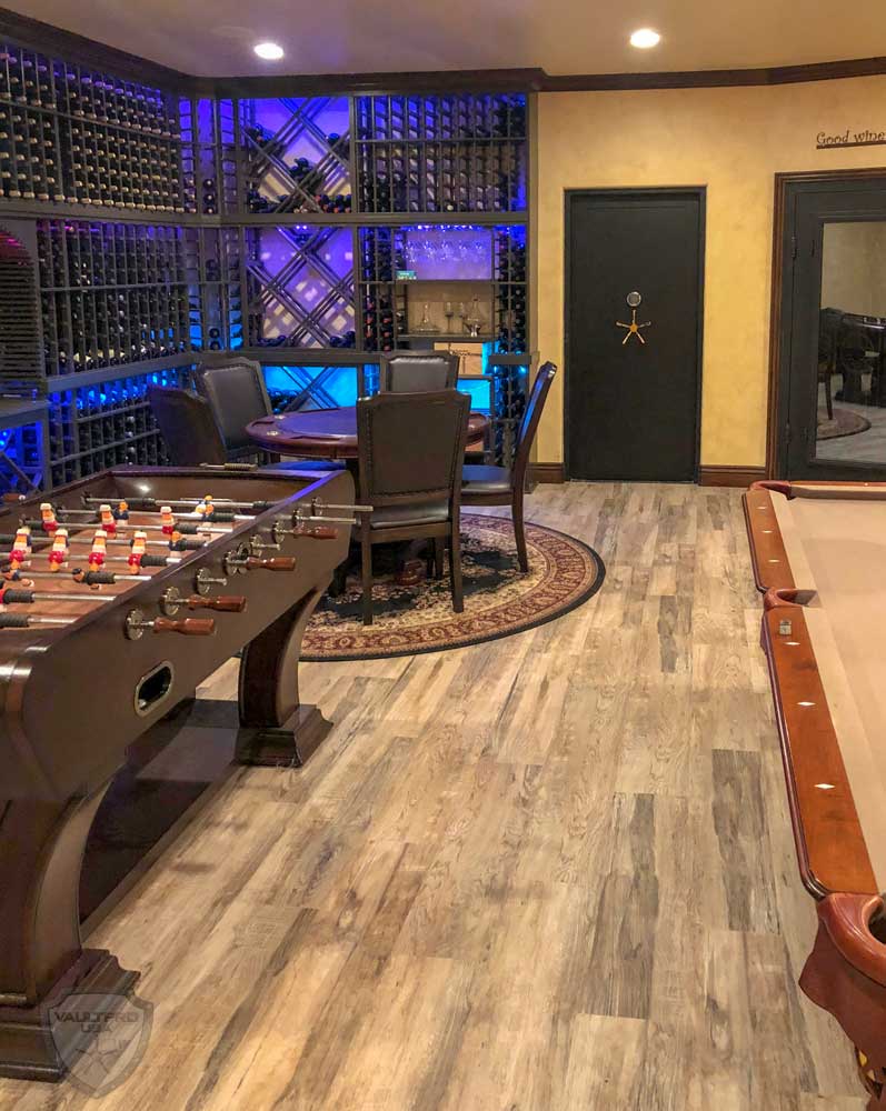 Game room with a pool table, foosball table, wine racks, and a small seating area.