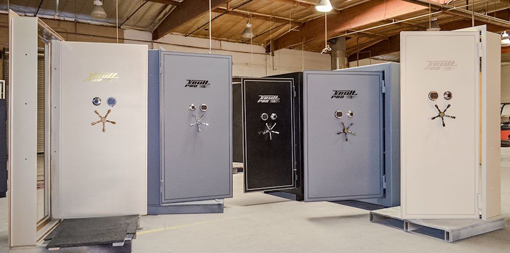 Five portable shower stalls in a warehouse, shown open with doors and shower fixtures visible.