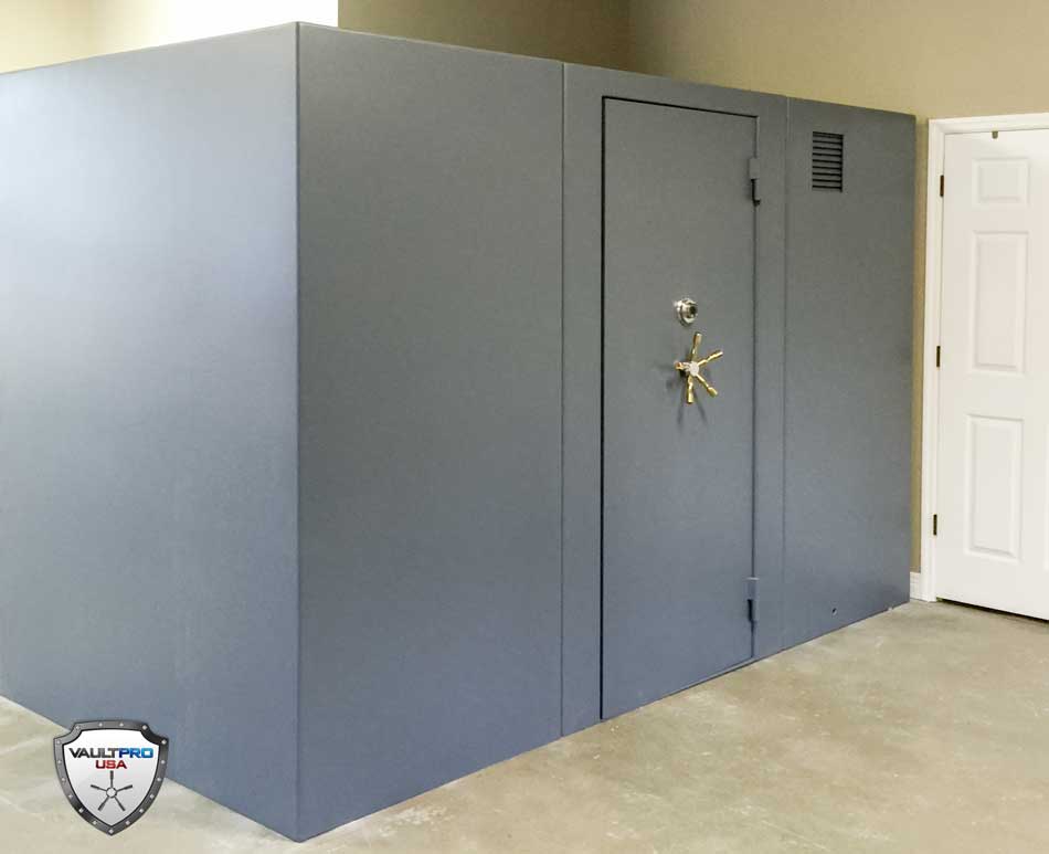 Gray vault-like room with a heavy door and star-shaped handle in a concrete interior.