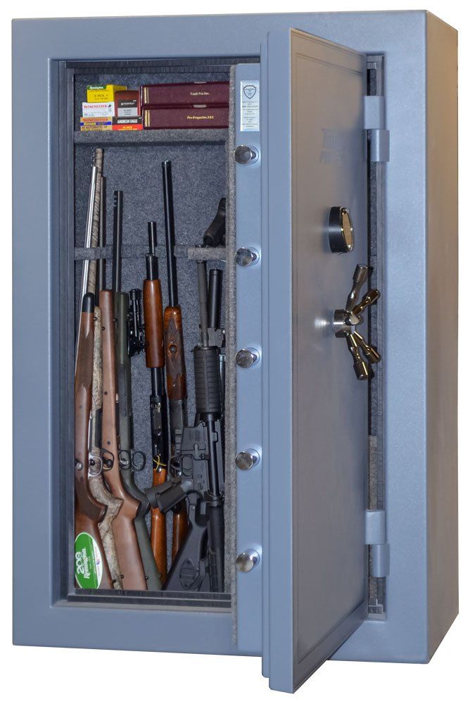Open gun safe with rifles and shotguns stored inside, gray steel door ajar.
