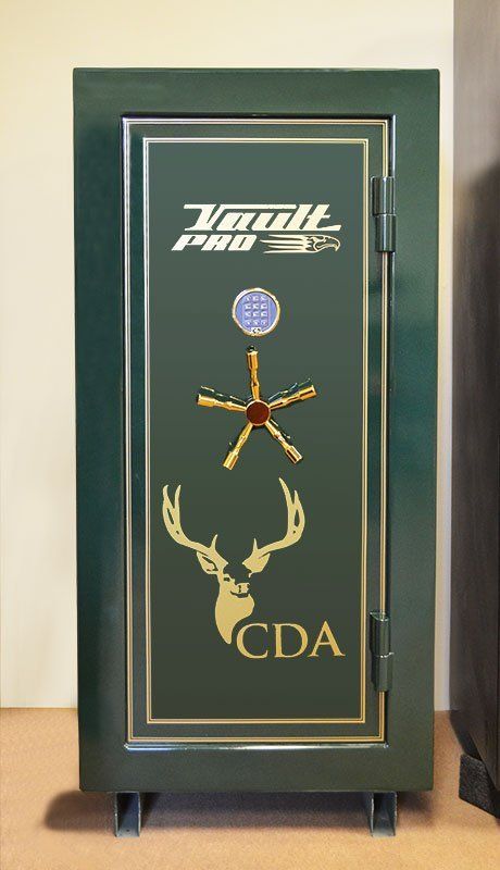 Green gun safe with gold trim, logo, deer antlers, and star-shaped handle on small legs