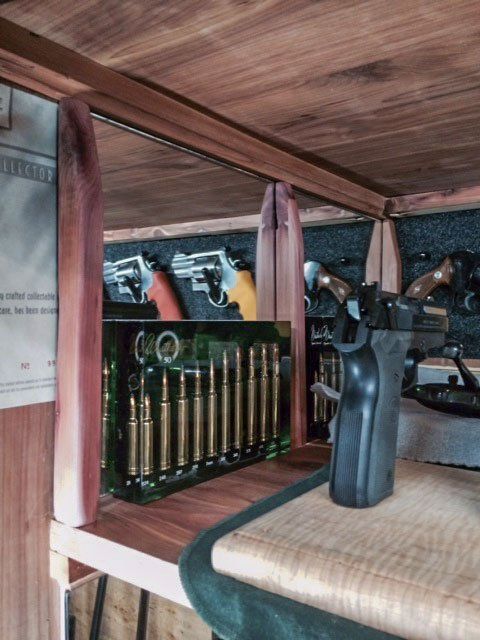Old wooden shelf with books and a black handgun inside a wicker basket