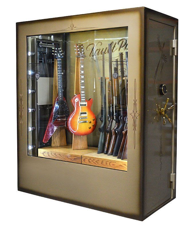 Wall-mounted display case with two electric guitars and several rifles on a wooden shelf.