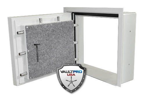 Open white wall safe with gray felt-lined door and black handle.