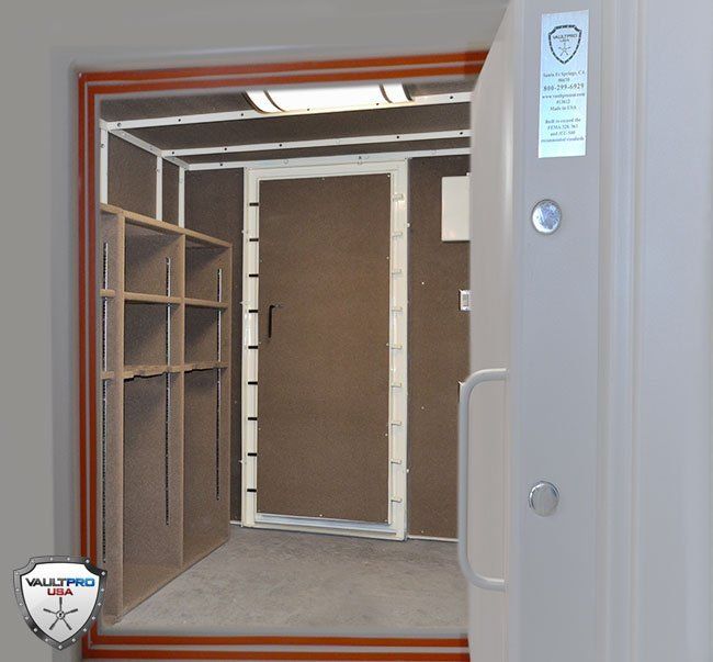 Open storage compartment with shelves and a closed brown door inside a gray metal cabinet.