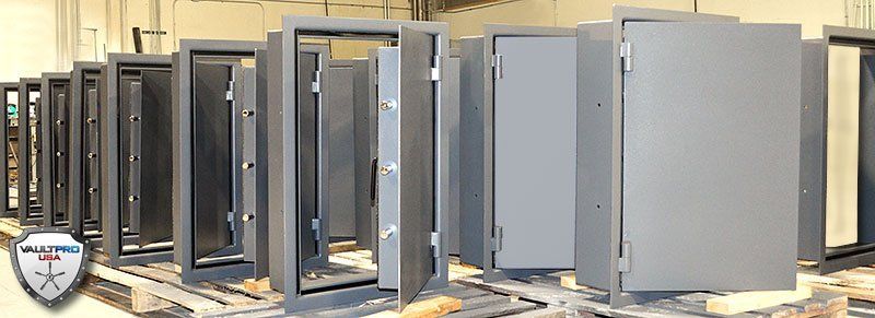 Row of industrial metal cabinets and enclosures in a warehouse-like setting
