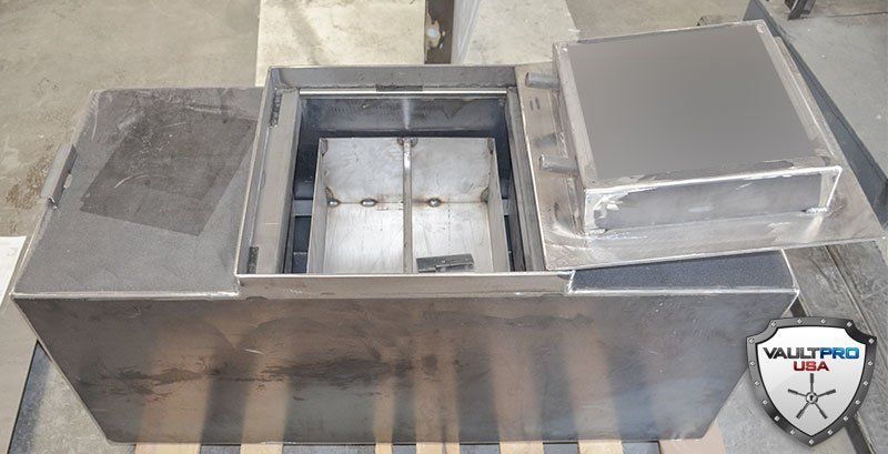 Metal rooftop HVAC unit with open center compartment and adjacent duct sections
