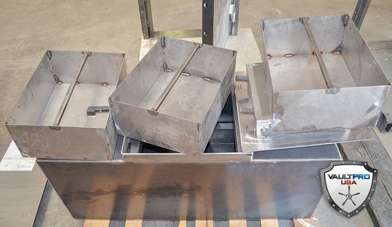 Three metal furnace molds on a workbench, with a Wallpro shield logo in the corner.
