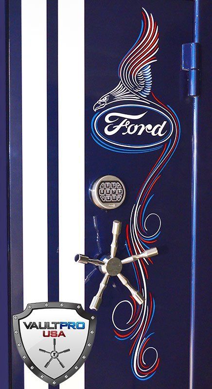 Blue Ford-themed display with winged logo, shield emblems, and decorative red-white-blue swirls