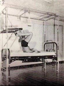 A black and white photo of a man laying on top of a hospital bed.