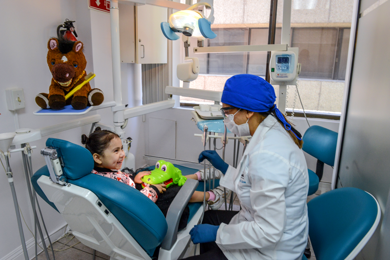 dentist assisting child at dentiland