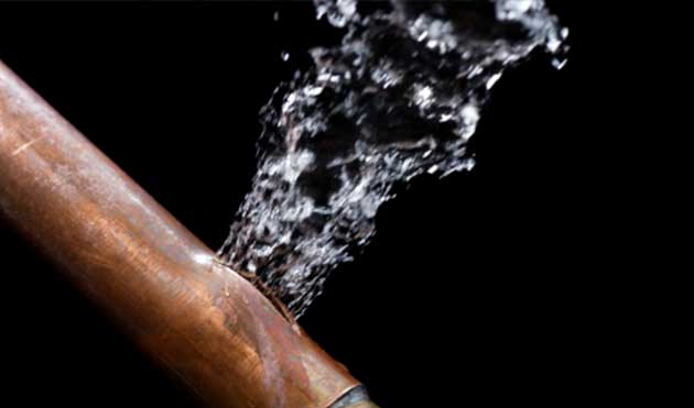 a close up of a copper pipe with water coming out of it .