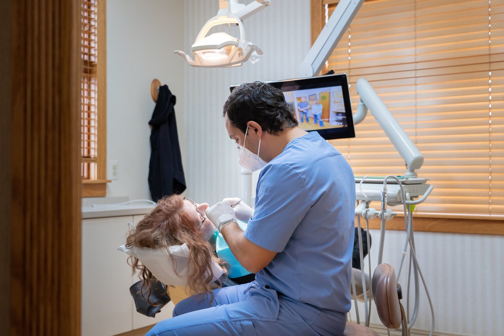 Dr. Hourani giving patient a dental exam at Tecumseh Family Dental Care