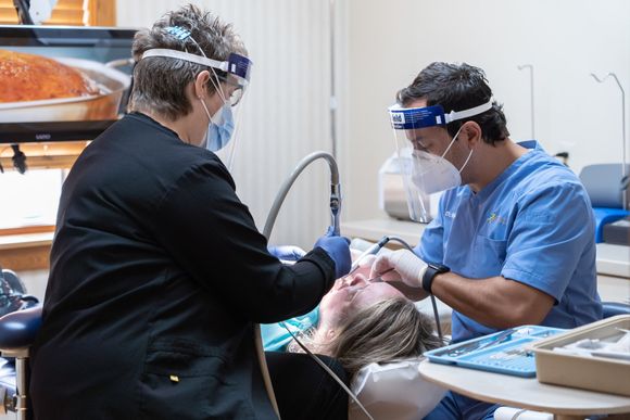 Dr. Hourani and Dental Hygienist helping patient at Tecumseh Family Dental Care