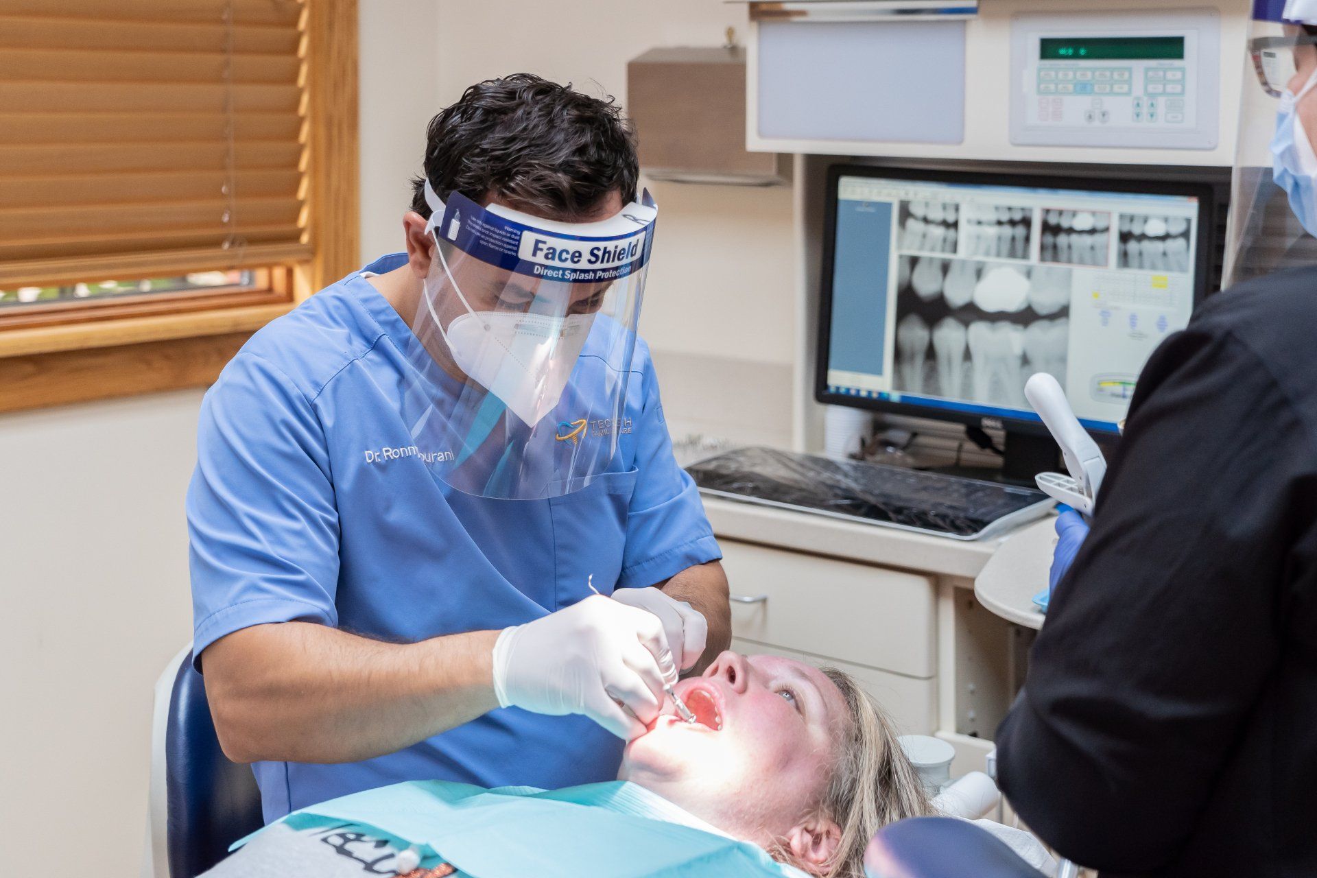 Dr. Hourani looking at x-rays with patient at Tecumseh Family Dental Care