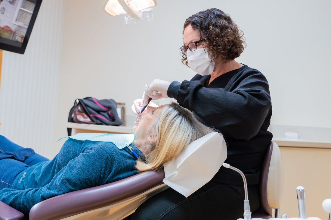 Dental hygienist with patient at Tecumseh Family Dental Care