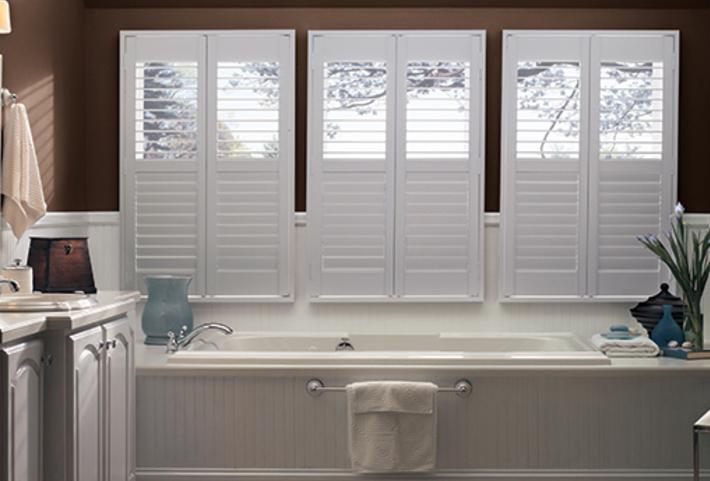 bathroom white composite shutters in bathroom windows.