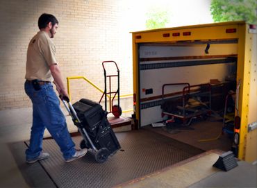 Office Furniture Delivery — Man Pushing Through Delivery Truck in Fort Wayne, IN