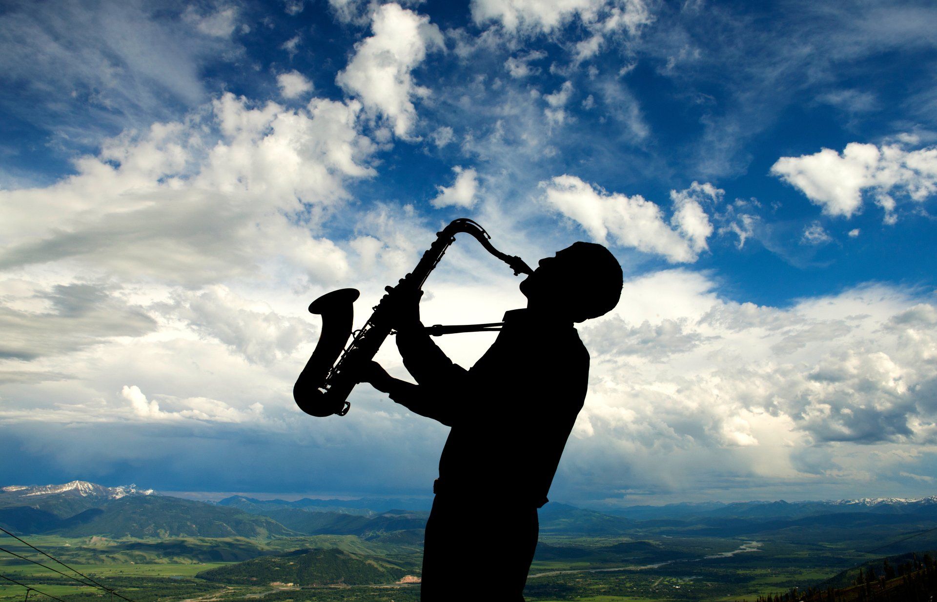silhouette of a man playing saxophone