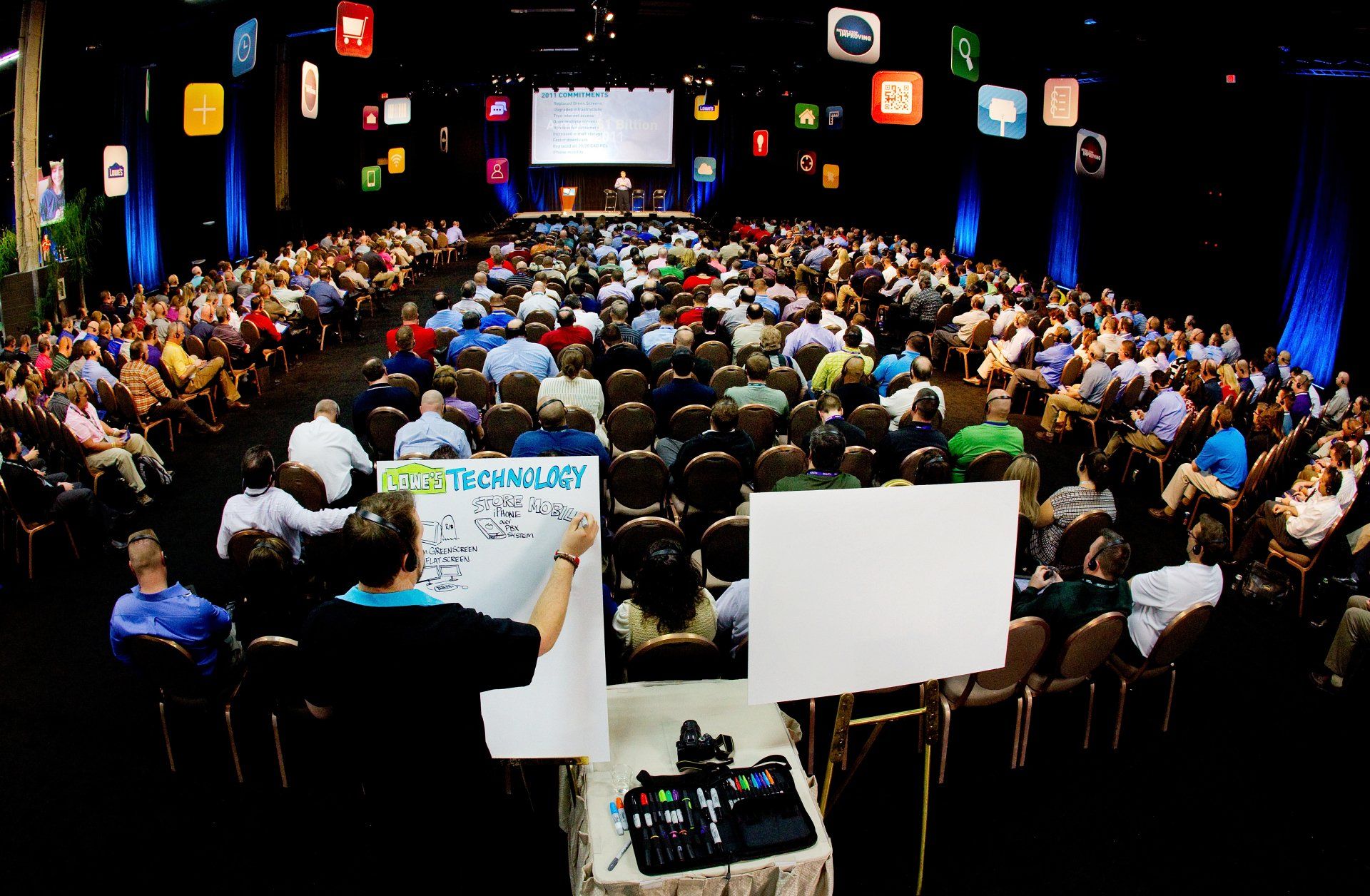 Illustrator making a live drawing at industry convention