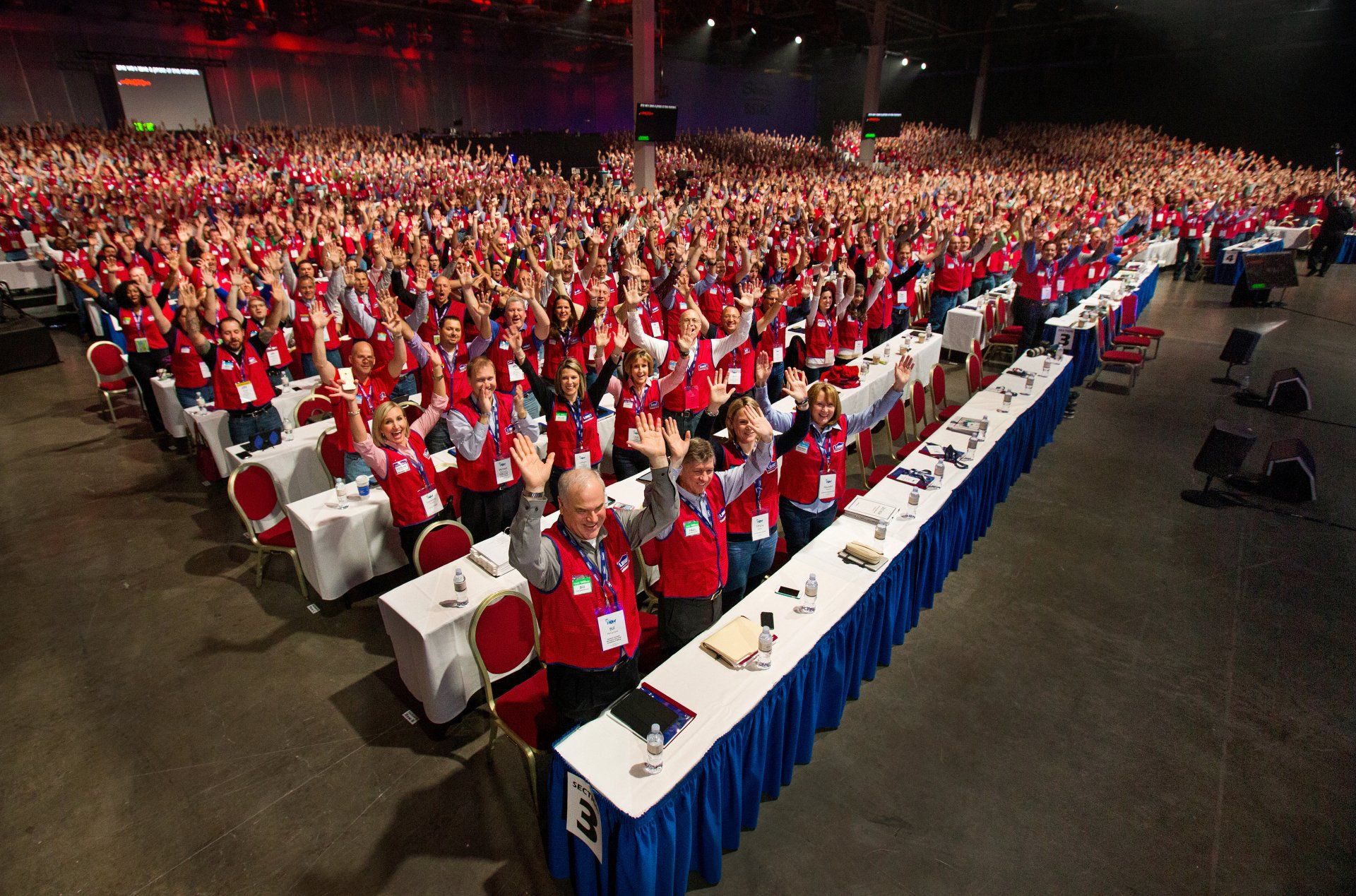 Employees in uniforms react to corporate success