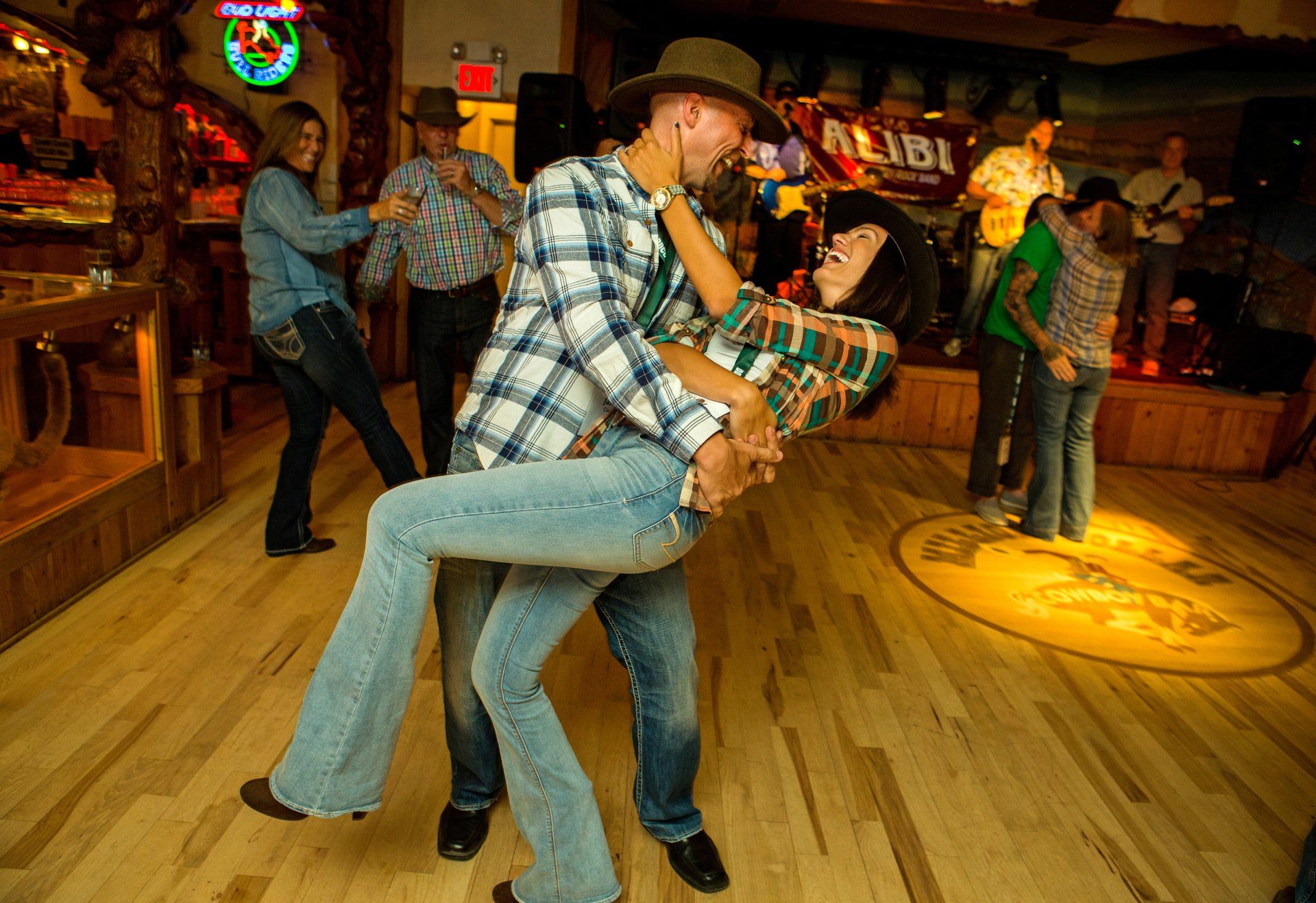 a couple dancing inside a western saloon