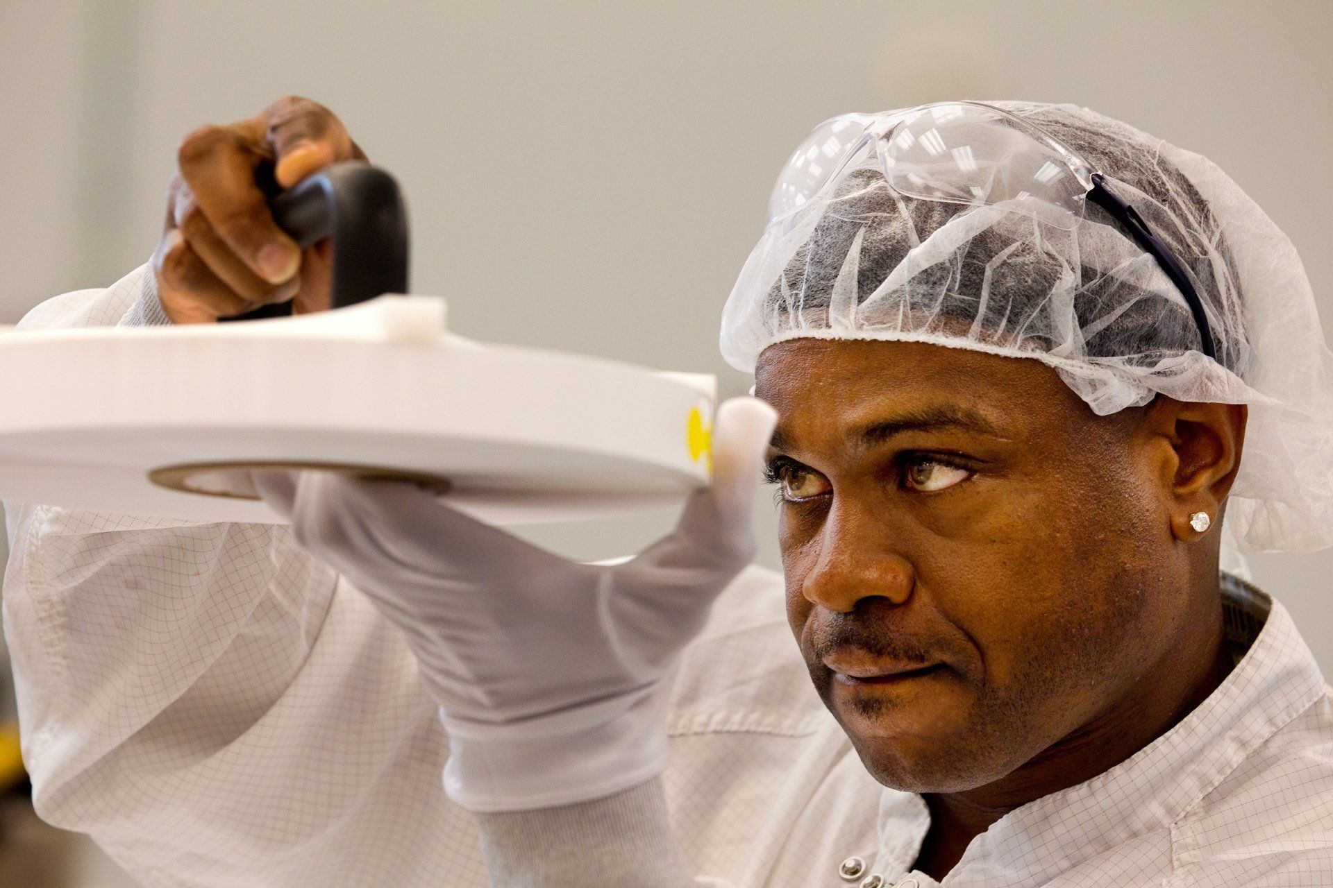 Scientist doing detail work in dust suit
