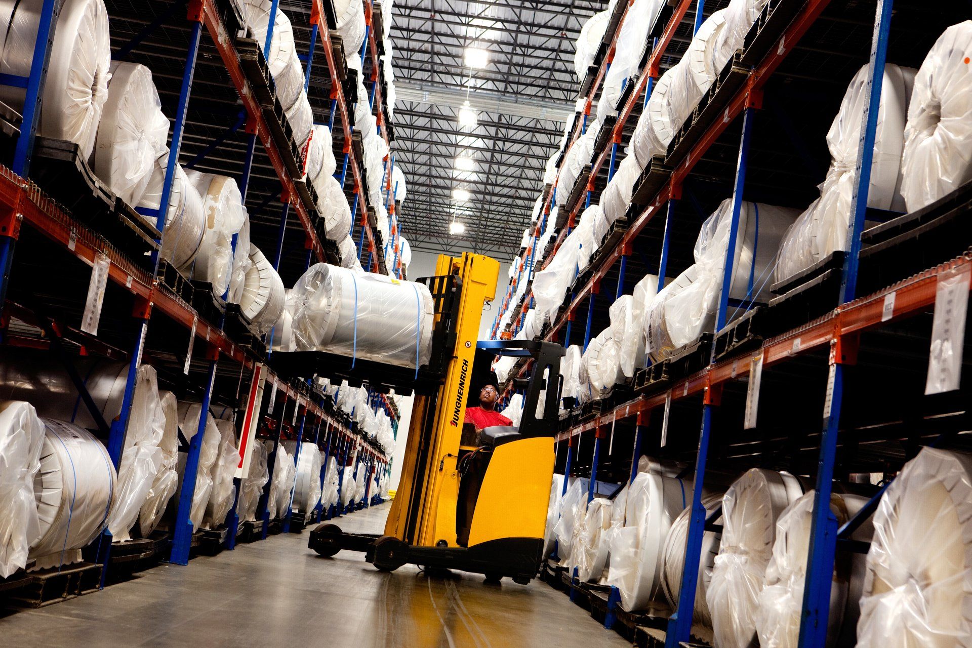 Safety first photography of employee operating forklift in industrial facility