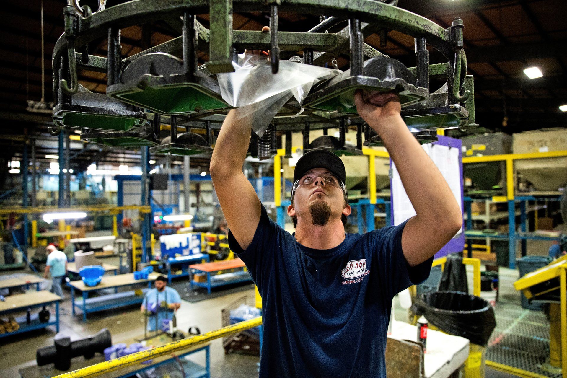 Plant worker on specialty equipment in a manufacturing facility