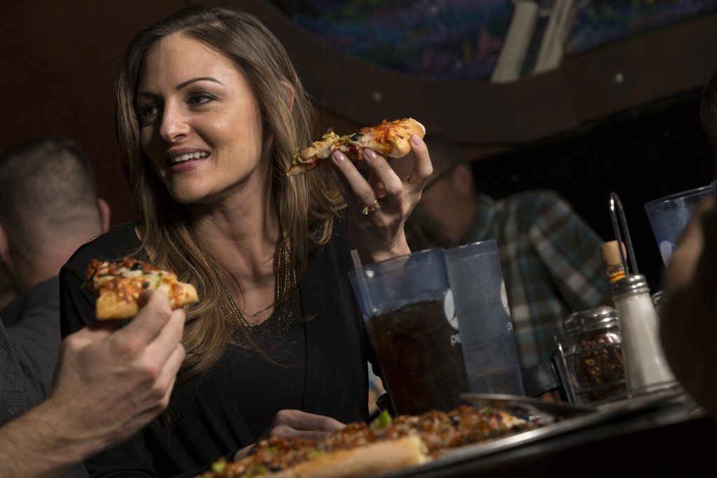 beautiful woman eating pizza
