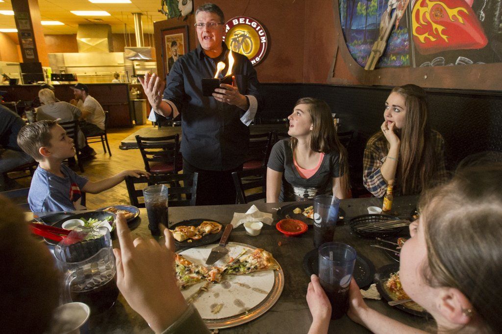 A magician doing tricks at pizza madness