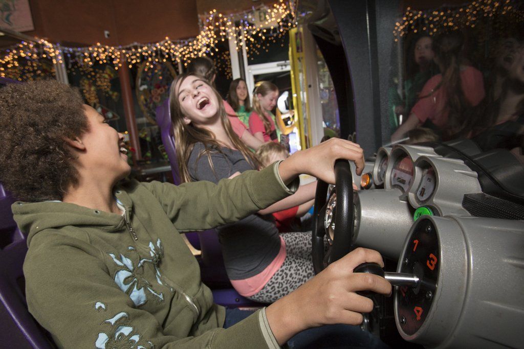 young kids playing arcade games at pizza madness