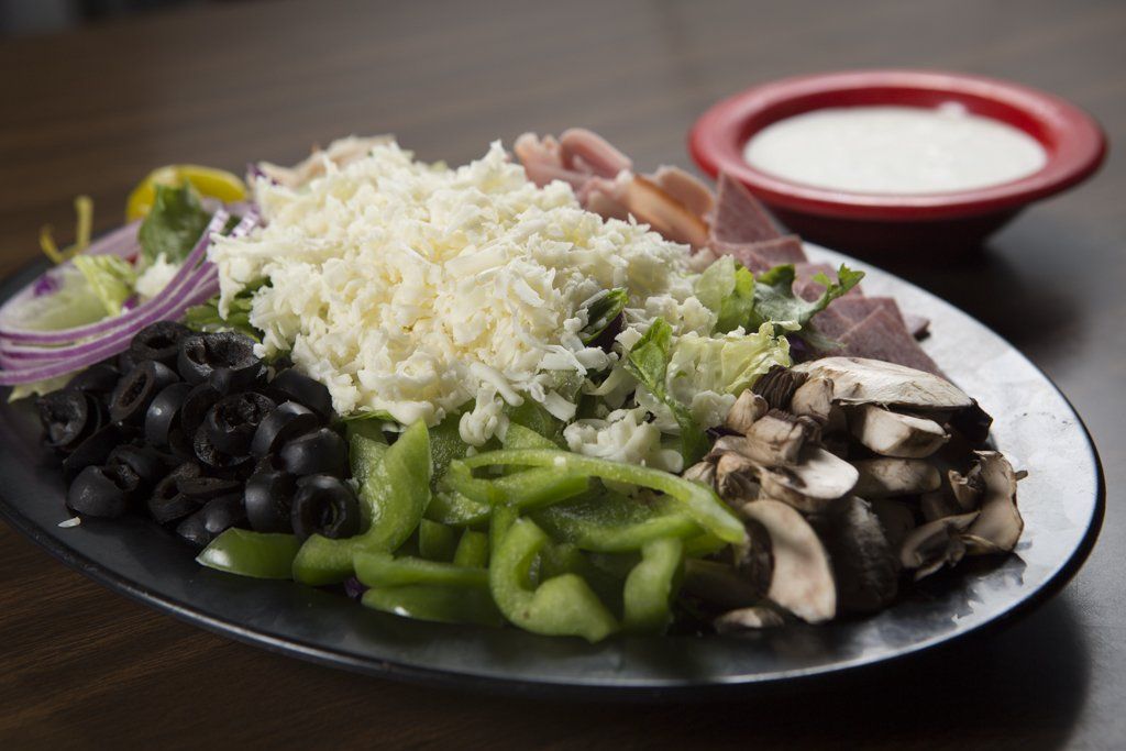 A fresh salad with dressing on side