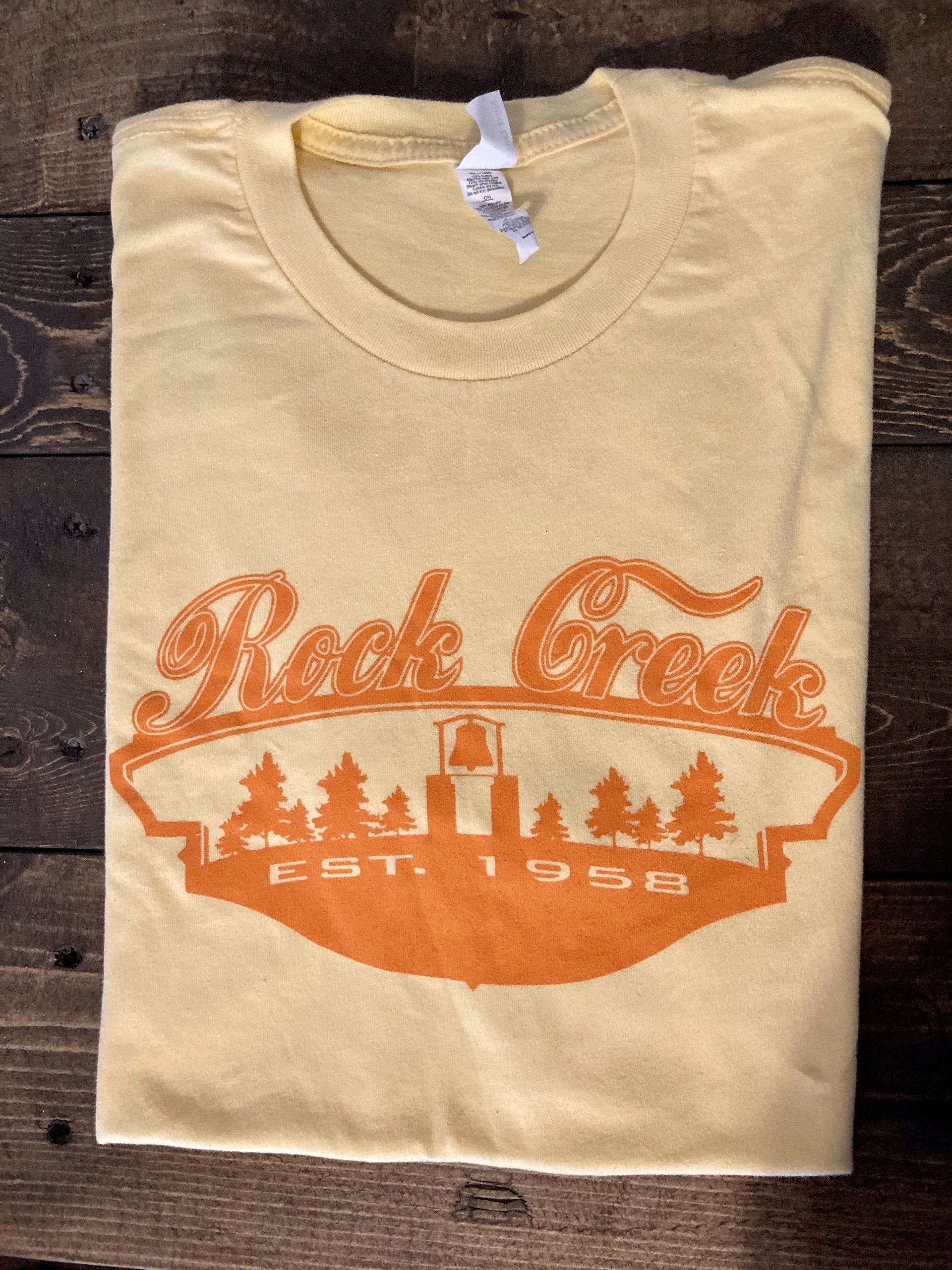 Yellow Rock Creek t-shirt with orange logo; trees, a building and 