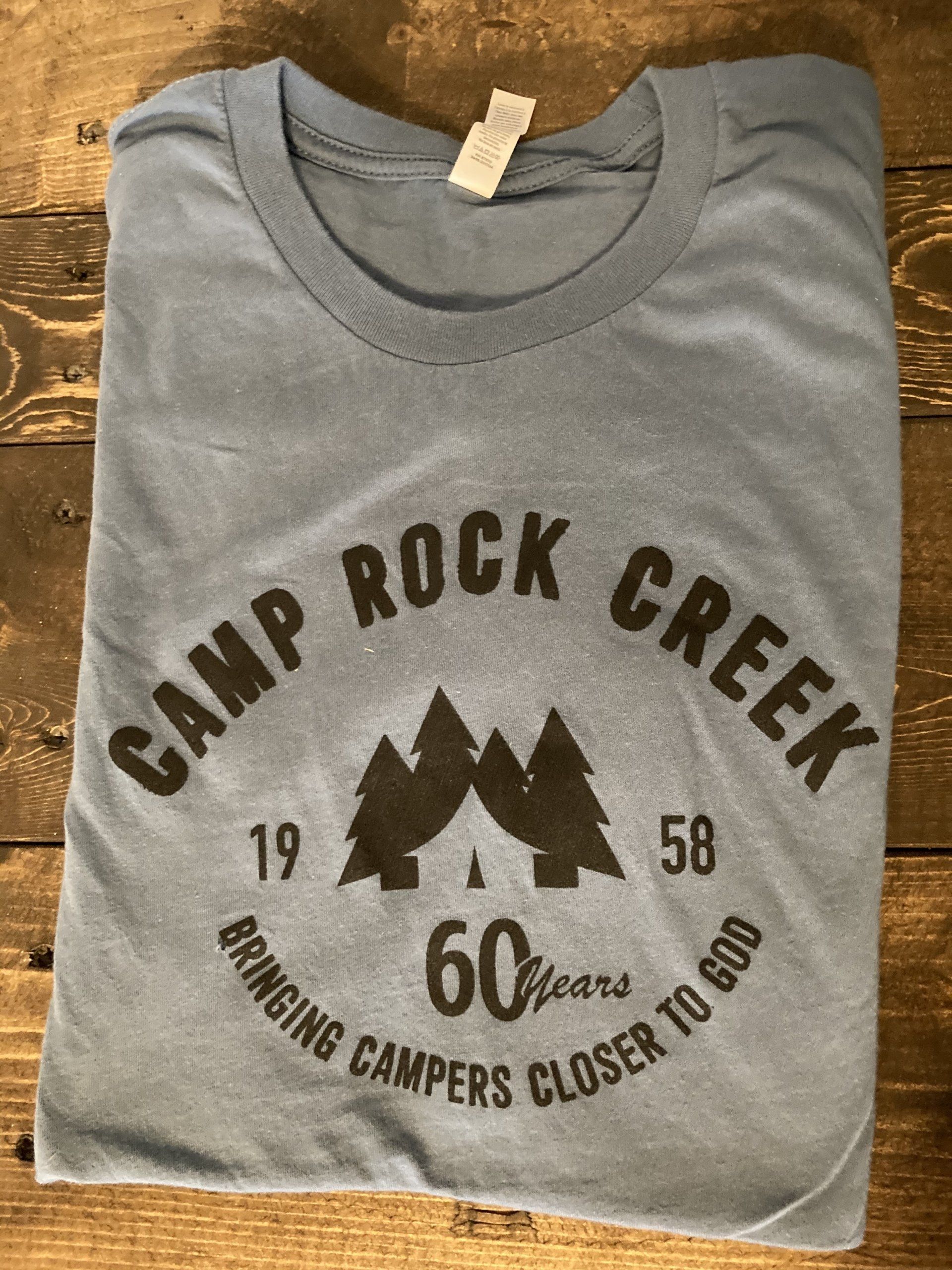 Blue Camp Rock Creek t-shirt with black logo: trees and text 